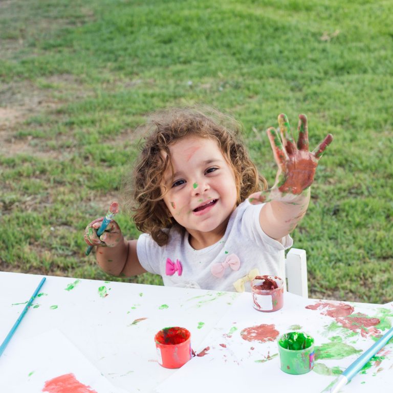 cute-girl-with-hands-painted-in-colorful-paints